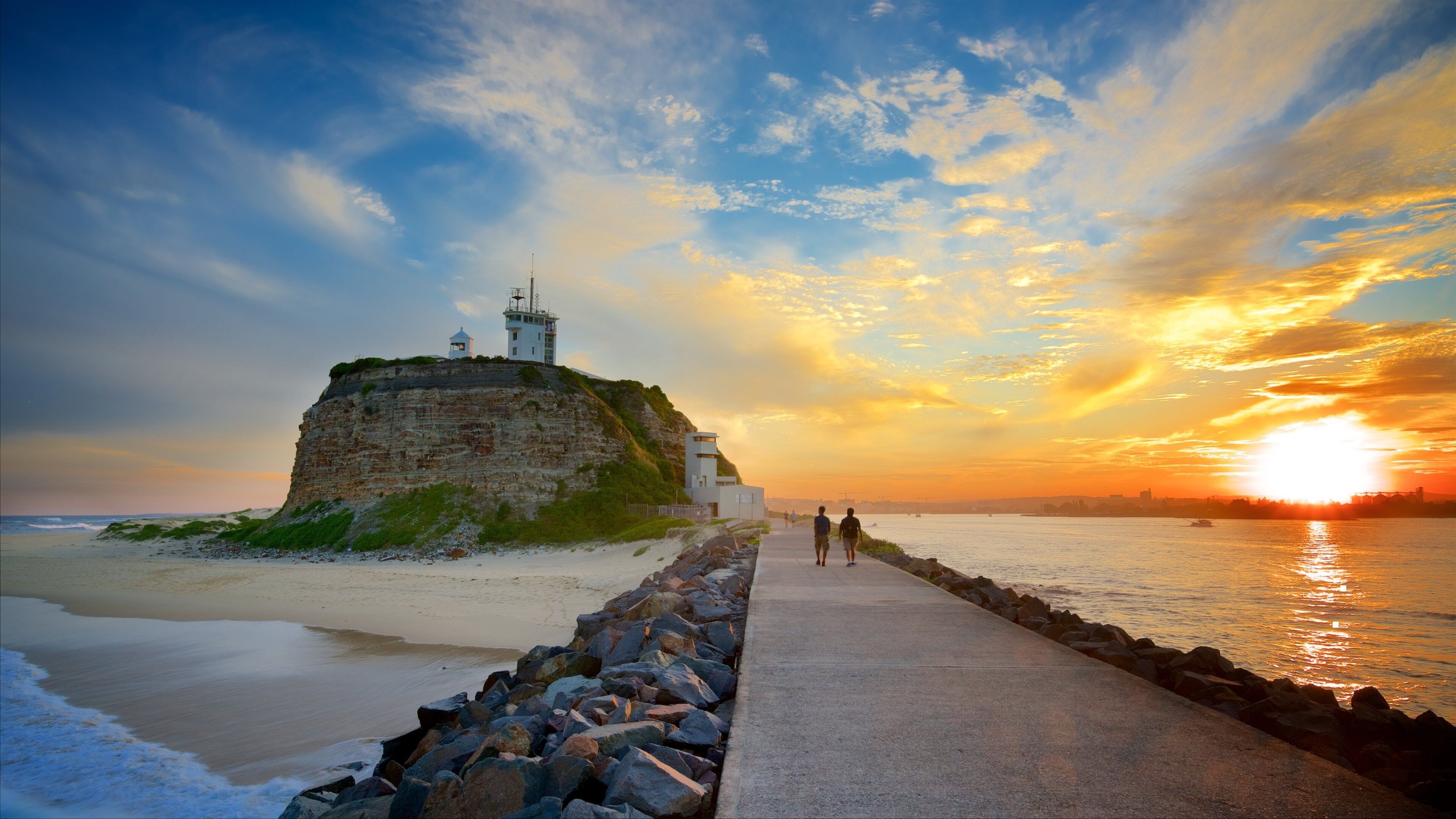 Newcastle East showing general coastal views and a sunset as well as a couple