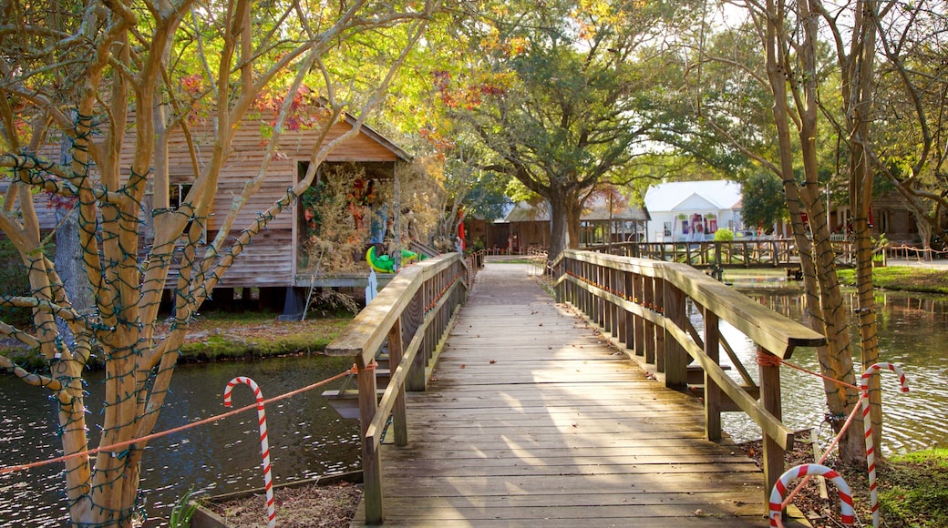 Acadian Village featuring a bridge and a pond
