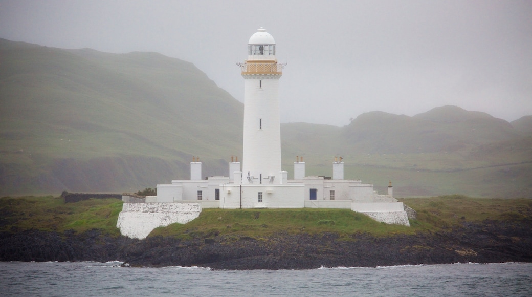 Isle of Mull featuring a lighthouse, rugged coastline and mist or fog