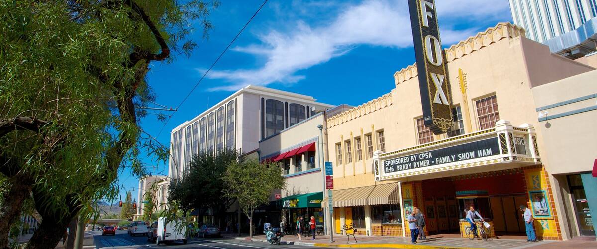 A street with a theater, a Subway, and a building with a 'FOX' sign.