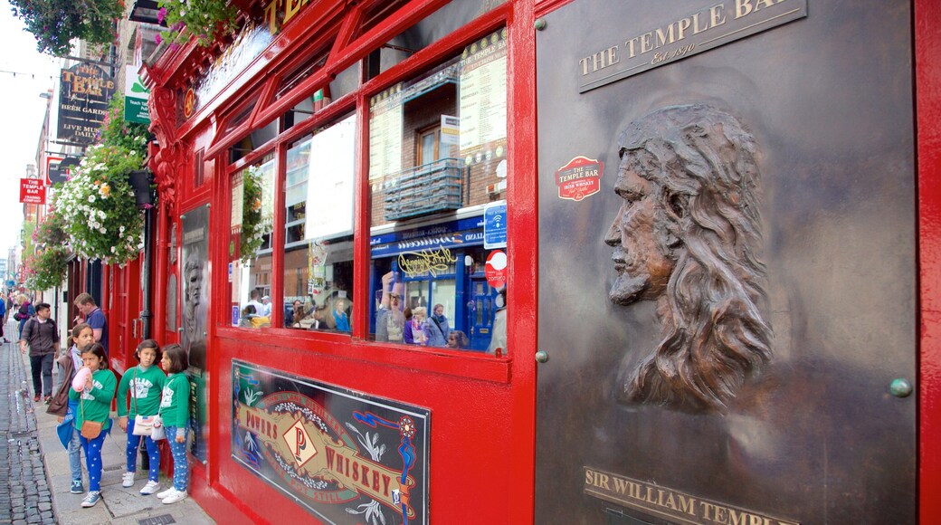 Temple Bar which includes signage and a bar as well as children