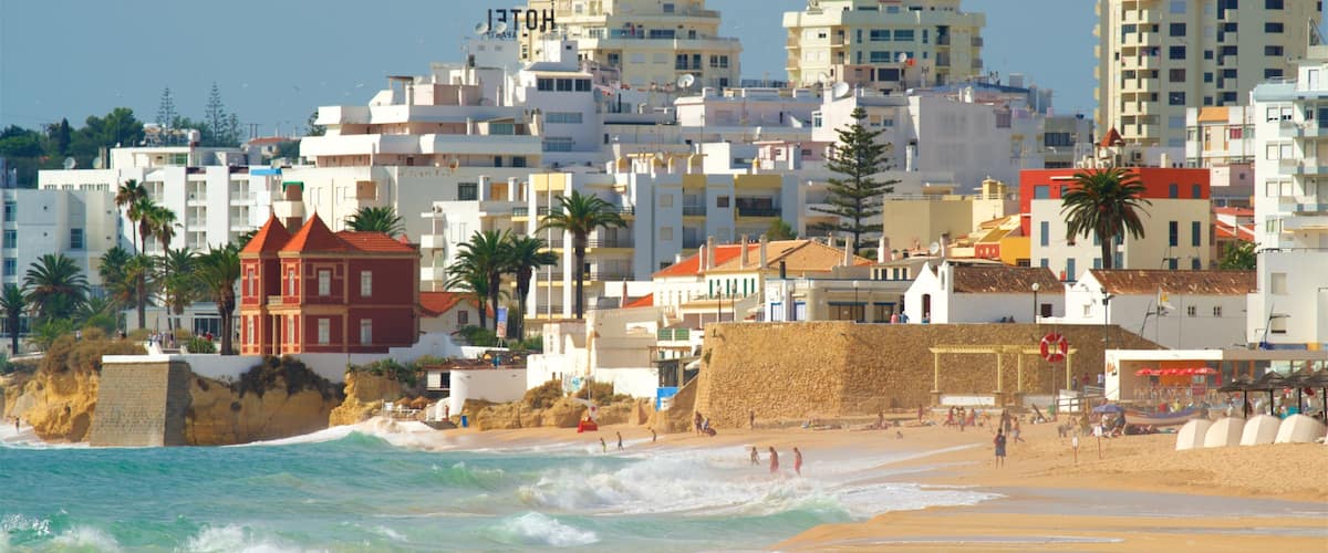 A coastal cityscape with sandy beaches, waves, and a mix of modern and traditional architecture.
