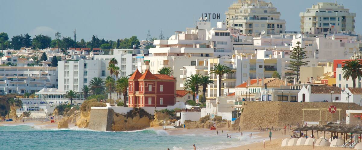 A coastal cityscape with a beach, palm trees, and a mix of modern and traditional architecture.