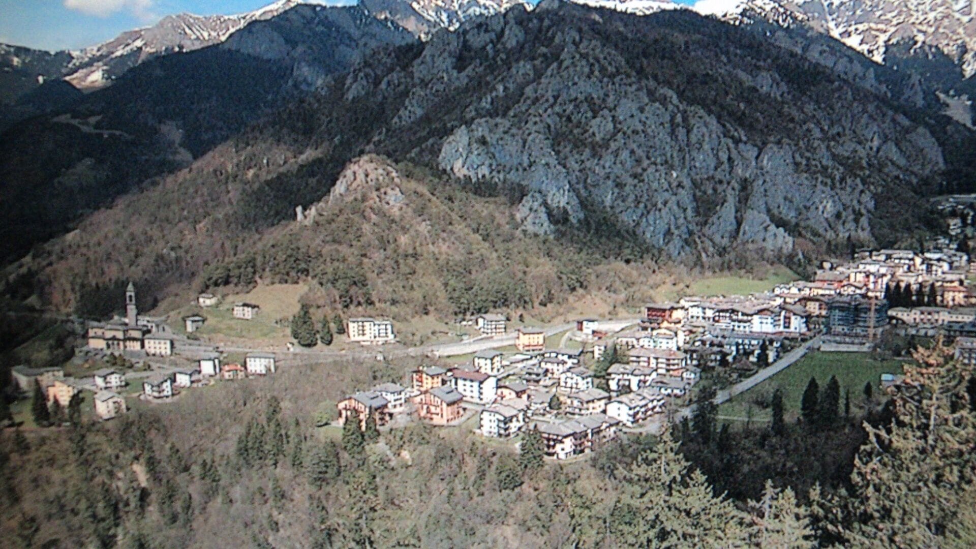 A mountainous village with buildings nestled among the hills.