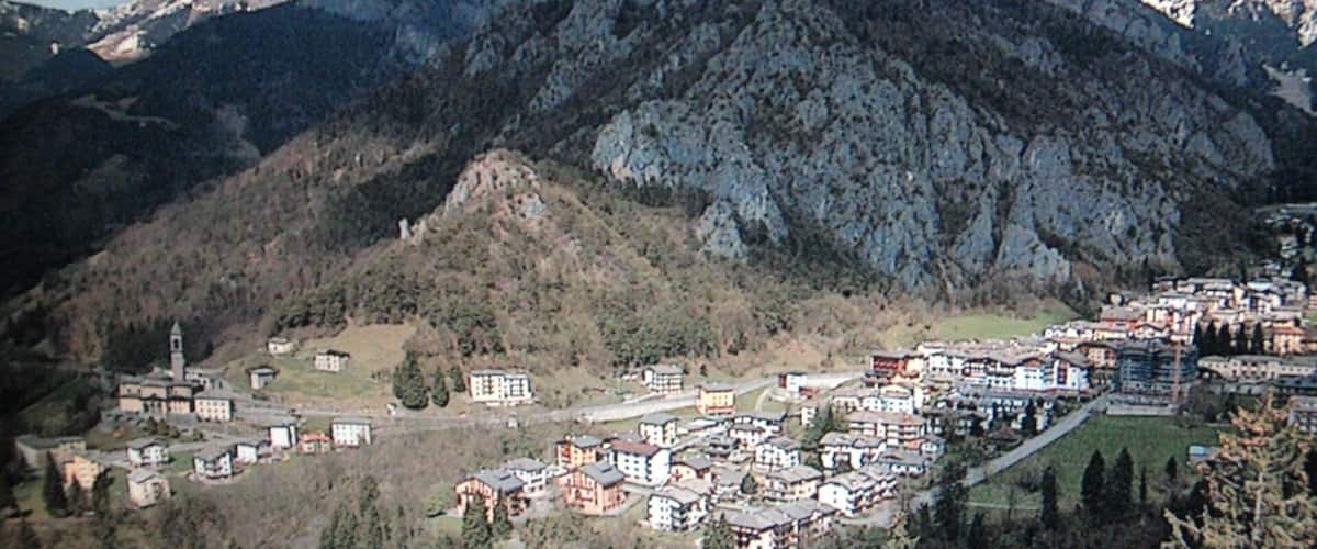 A mountainous village with buildings nestled among the hills.