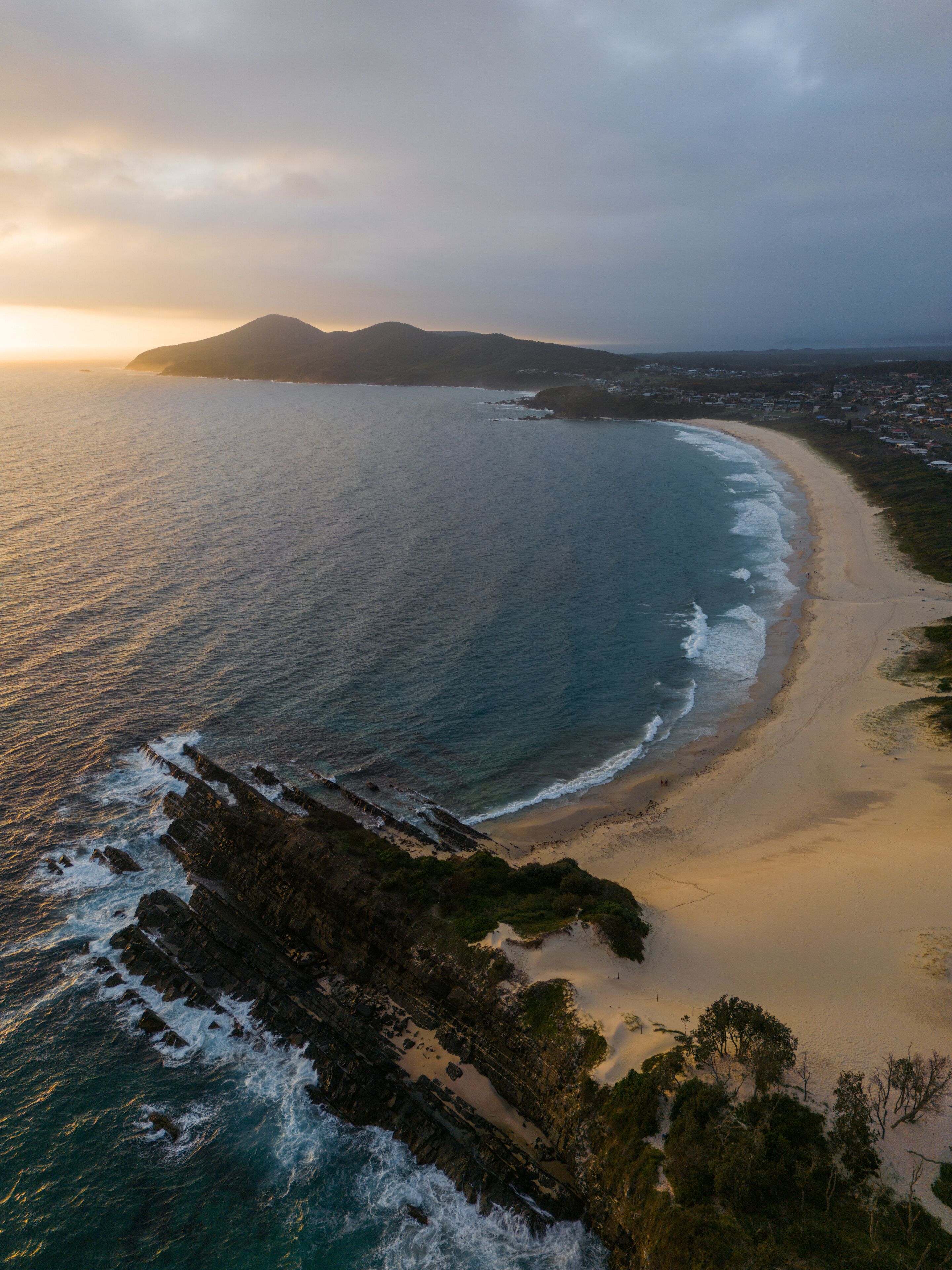 Aerial view of One Mile Beach, Forster, Australia with cloudy sky.