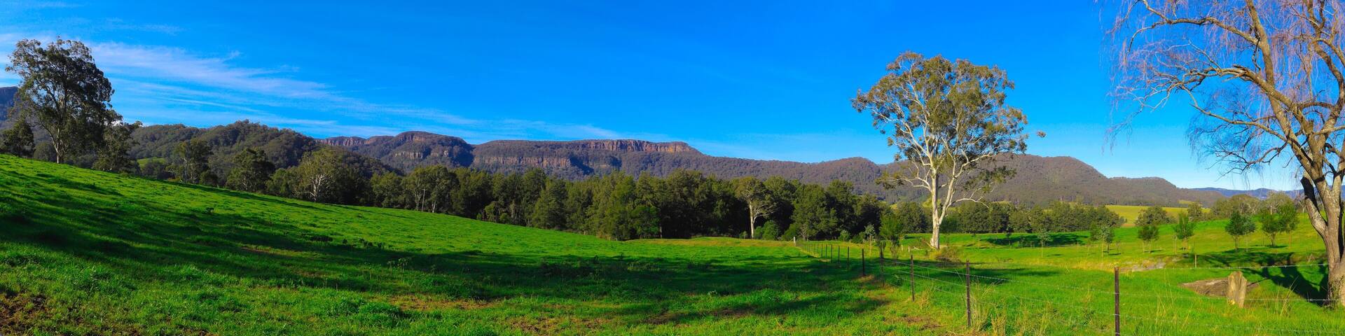 Panorama southern highlands Kangaroo Valley and Berry country town lush green pastures blue skies