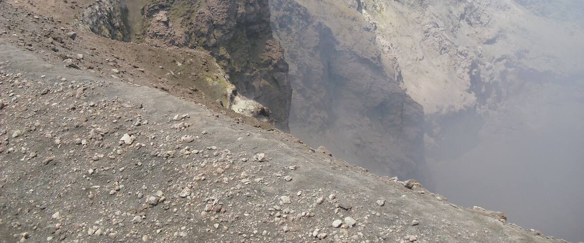 A rugged mountain landscape with rocky terrain and a steep incline.
