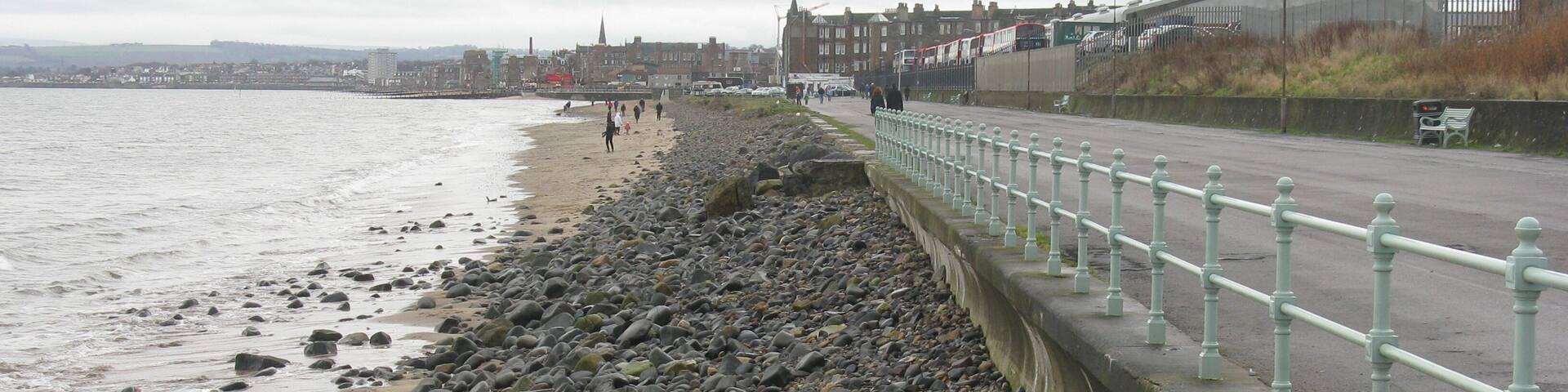 The view south down the beach and promenade in Portobello. The big shed on the right is the end of Marine garage of Lothian Buses.