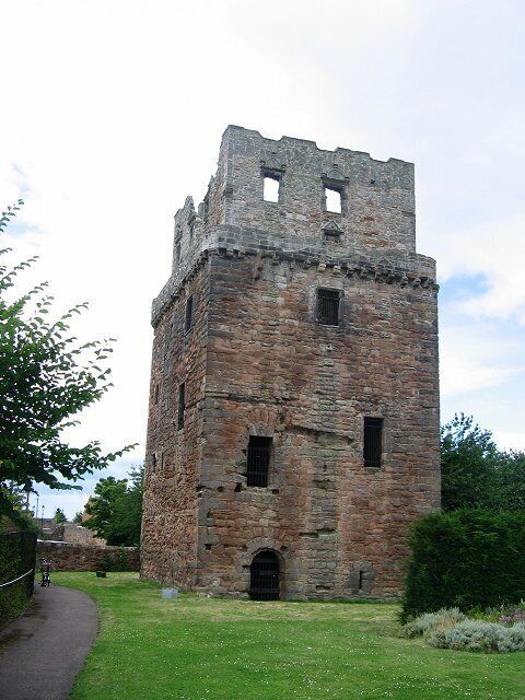 A historic stone tower with a narrow entrance and a small arched doorway.