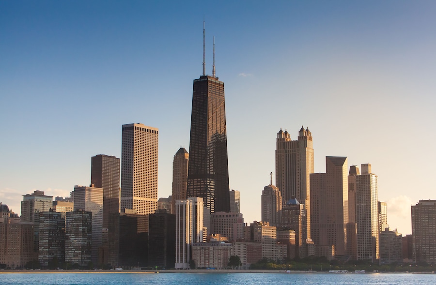 Chicago Illinois city sunset skyline and cityscape from Lake Michigan with John Hancock Building in the center. Evening light in the summer from sailboat at the playpen.