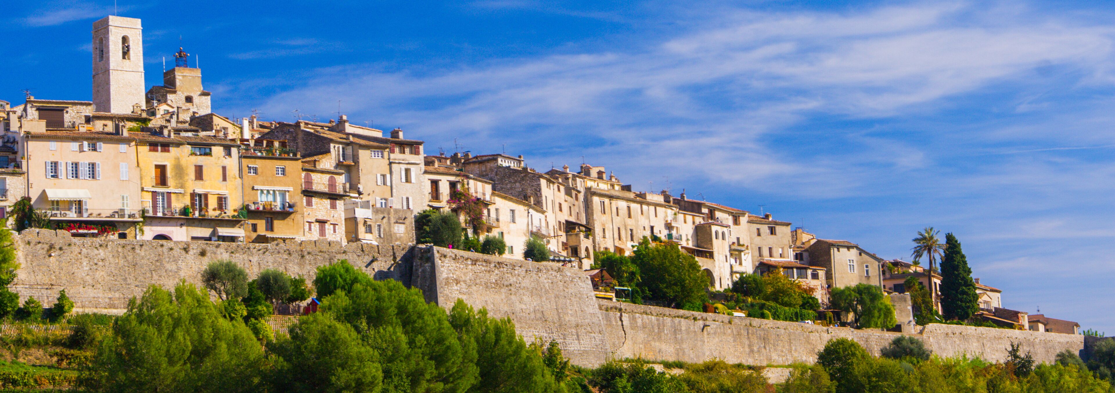 A historic town with stone buildings and a prominent tower.