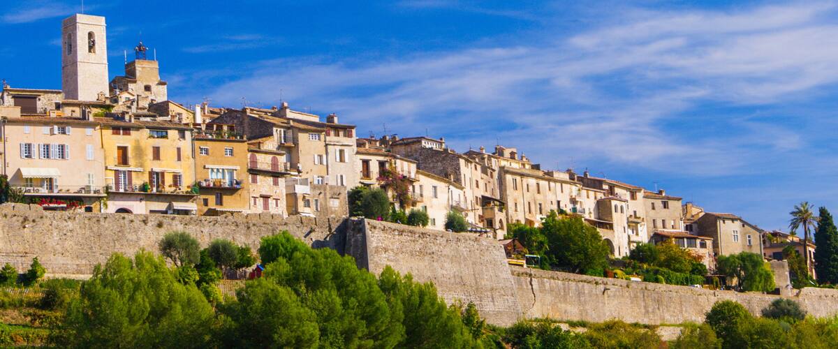 A historic town with stone buildings and a prominent tower.