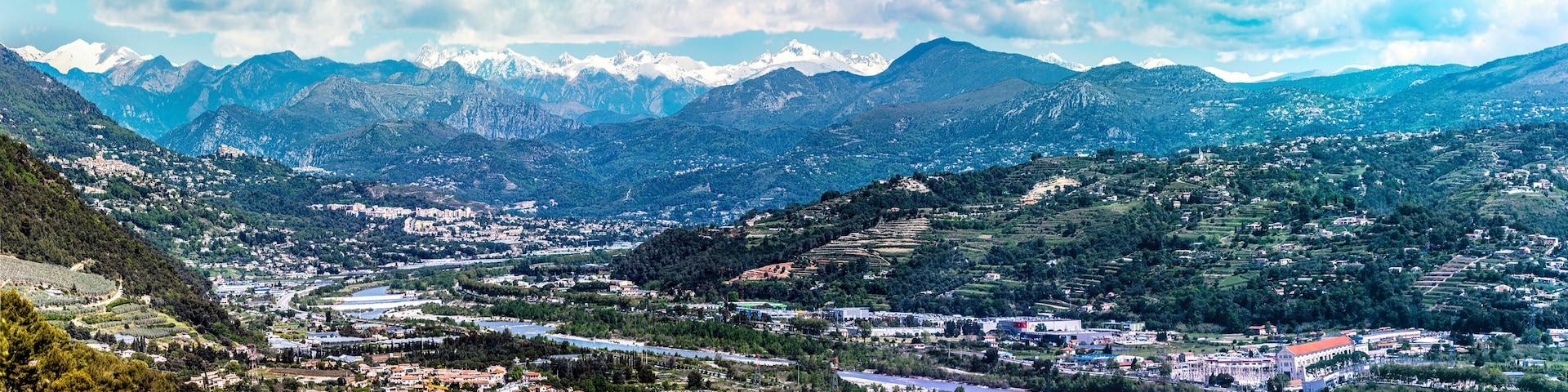 Panoramic view of Var Valley from Saint Laurent du Var village, the suburb of Nice city. Mountains of Mercantour National Park isa at background. French Riviera.