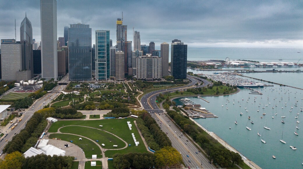 View of Downtown Chicago buildings looking north over Grant Park with Lake Michigan and Lake Shore Drive on right side. Prudential Building and Standard Oil Buildings on left side.