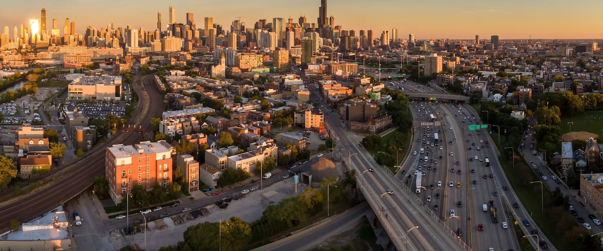 Chicago cityscape at sunset, showing the city's diverse architecture and busy highway traffic. Urban sprawl and transportation infrastructure. Goose Island, Chicago, Illinois, United States