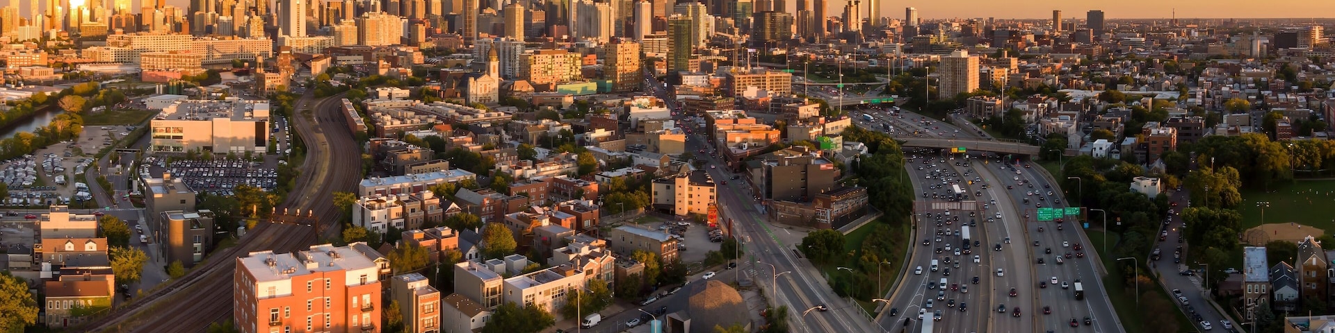 Chicago cityscape at sunset, showing the city's diverse architecture and busy highway traffic. Urban sprawl and transportation infrastructure. Goose Island, Chicago, Illinois, United States