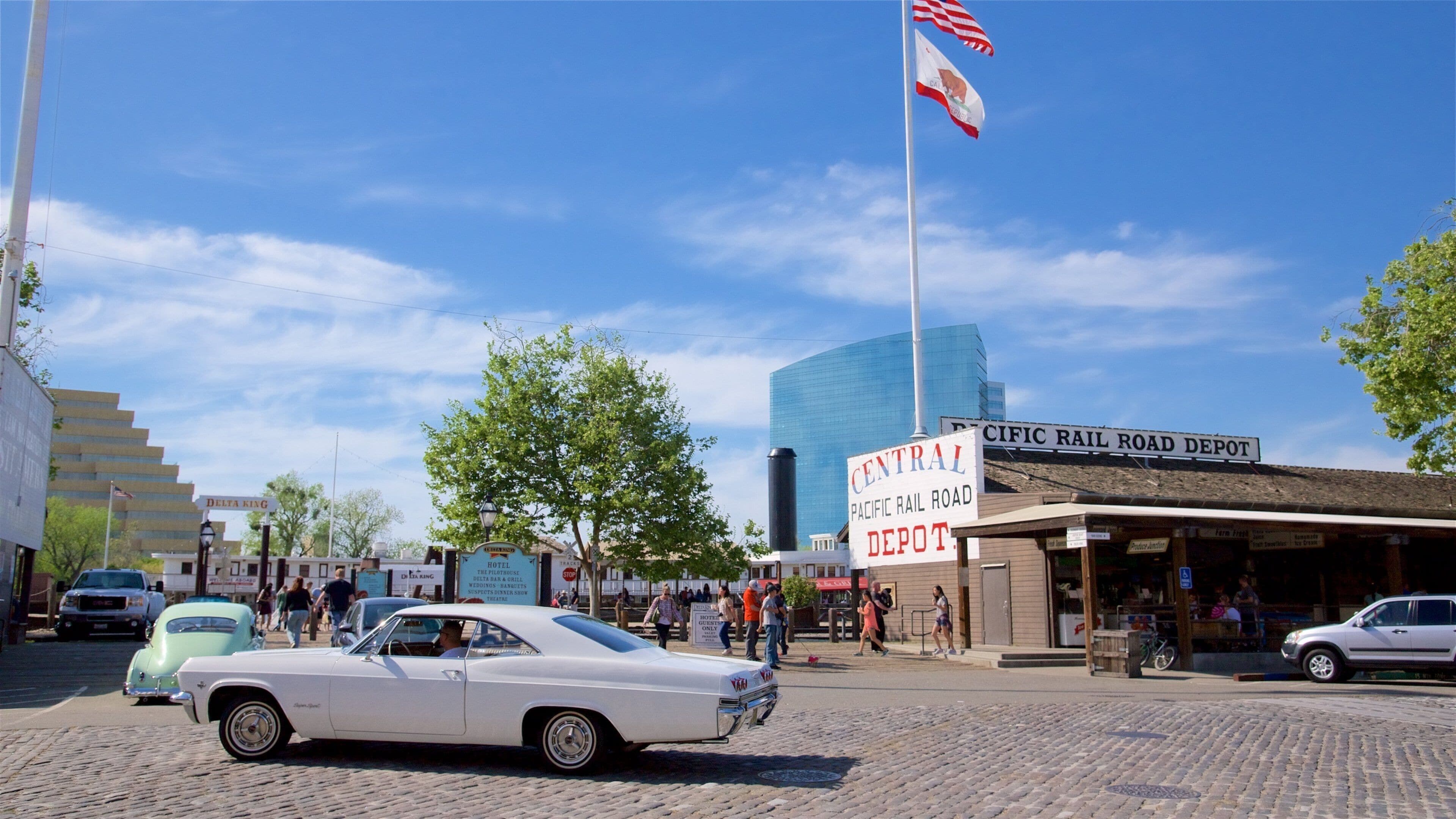 A vintage car, a hotel, and a Pacific Rail Road Depot.