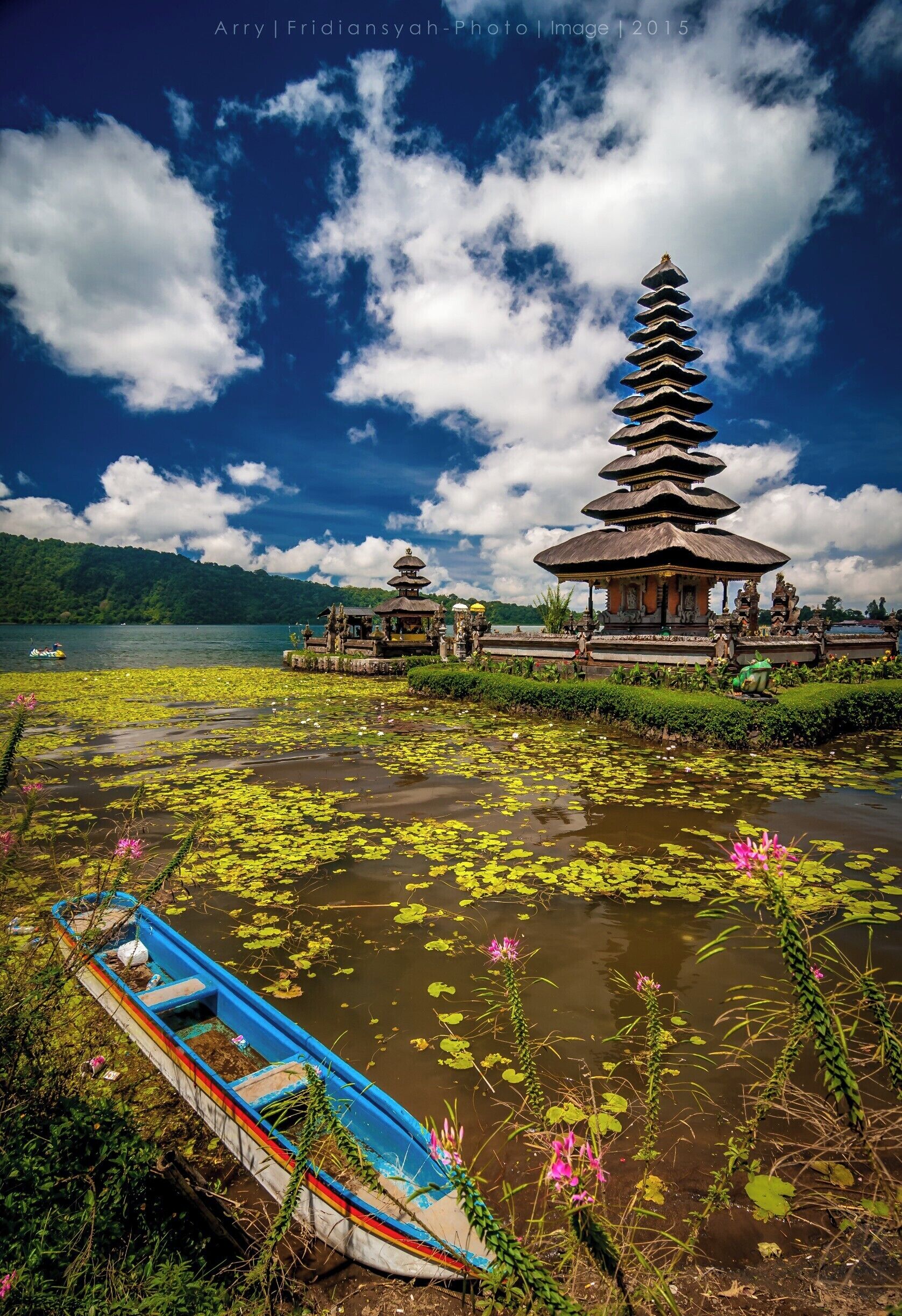 View Of Pure Ulun Danu Beratan - Bali

Pura Ulun Danu Beratan, or Pura Beratan, is a major Shivaite and water temple on Bali, Indonesia. The temple complex is located on the shores of Lake Bratan in the mountains near Bedugul. Water temples serve the entire region in the outflow area; downstream there are many smaller water temples that are specific to each irrigation association (subak)

Built in 1663, this temple is used for offerings ceremony to the Balinese water, lake and river goddess Dewi Danu, due to the importance of Lake Bratan as a main source of irrigation in central Bali. The 11 stories of pelinggih meru dedicated for Shiva and his consort Parvathi. Buddha statue also present inside this temple.

Lake Bratan is known as the Lake of Holy Mountain due to the fertility of this area. Located 1200 m above sea level, it has a cold tropical climate

[Wikipedia]