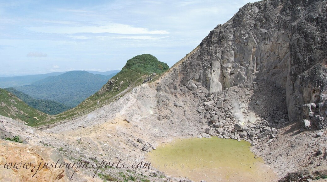 This volcano is active with steam vents and hot springs. However, it has not errupted since 1881. You can take a public bus to the bottom of the park and then walk to the peak. The majority of the way up is on a paved road - which totally sucks in my opinion - but then you get to the base camp where the road ends. Continue on the path up to the top and explore away! We spent between 2-3 hours once we reached the top, climbing different areas and so on. The view of Mt. Sinabung is incredible, especially since it was erupting while we were here. You can take a different way down, ending by hot springs in a small town, which is much nicer than the way up.