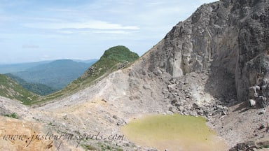 This volcano is active with steam vents and hot springs. However, it has not errupted since 1881. You can take a public bus to the bottom of the park and then walk to the peak. The majority of the way up is on a paved road - which totally sucks in my opinion - but then you get to the base camp where the road ends. Continue on the path up to the top and explore away! We spent between 2-3 hours once we reached the top, climbing different areas and so on. The view of Mt. Sinabung is incredible, especially since it was erupting while we were here. You can take a different way down, ending by hot springs in a small town, which is much nicer than the way up.