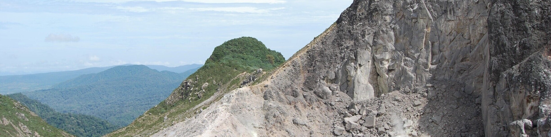 This volcano is active with steam vents and hot springs. However, it has not errupted since 1881. You can take a public bus to the bottom of the park and then walk to the peak. The majority of the way up is on a paved road - which totally sucks in my opinion - but then you get to the base camp where the road ends. Continue on the path up to the top and explore away! We spent between 2-3 hours once we reached the top, climbing different areas and so on. The view of Mt. Sinabung is incredible, especially since it was erupting while we were here. You can take a different way down, ending by hot springs in a small town, which is much nicer than the way up.
