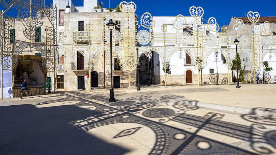 A street with ornate buildings and decorative patterns on the pavement.