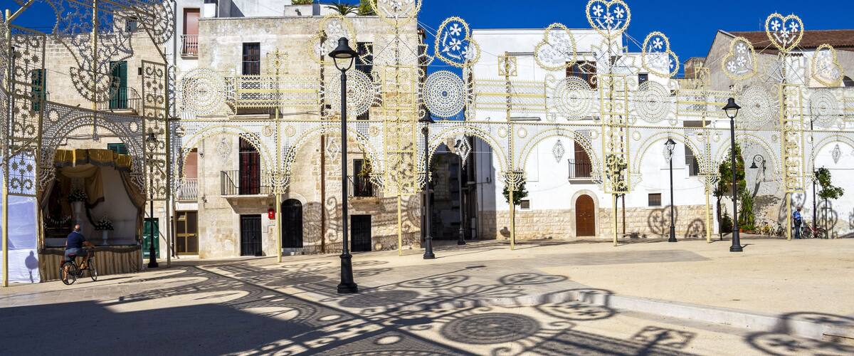 A street with ornate buildings and decorative patterns on the pavement.