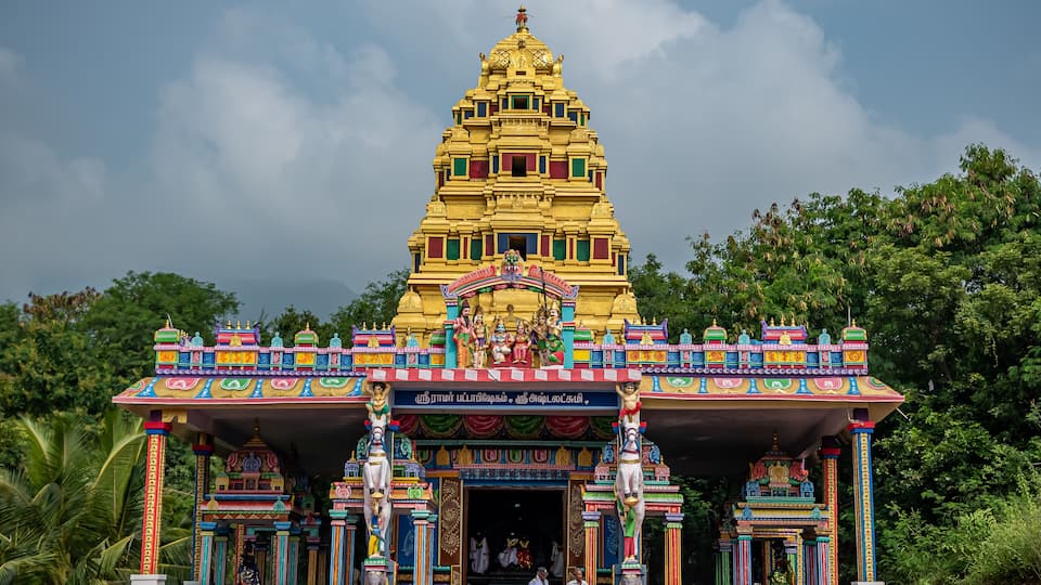 A colorful temple with intricate architecture and statues.