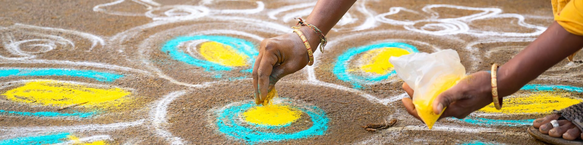 Kolam, colorful sandpainting with rice powder drawn by women and girls at the evening of Holi festival in India, indian religion and culture, hinduism celebration