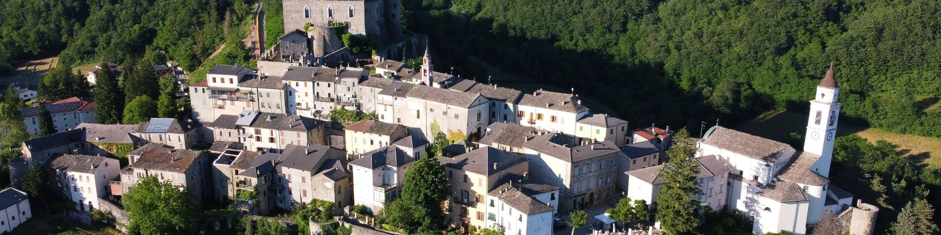 Aerial view of the small village of Compiano and the castle of Compiano. Compiano, Parma, Italy