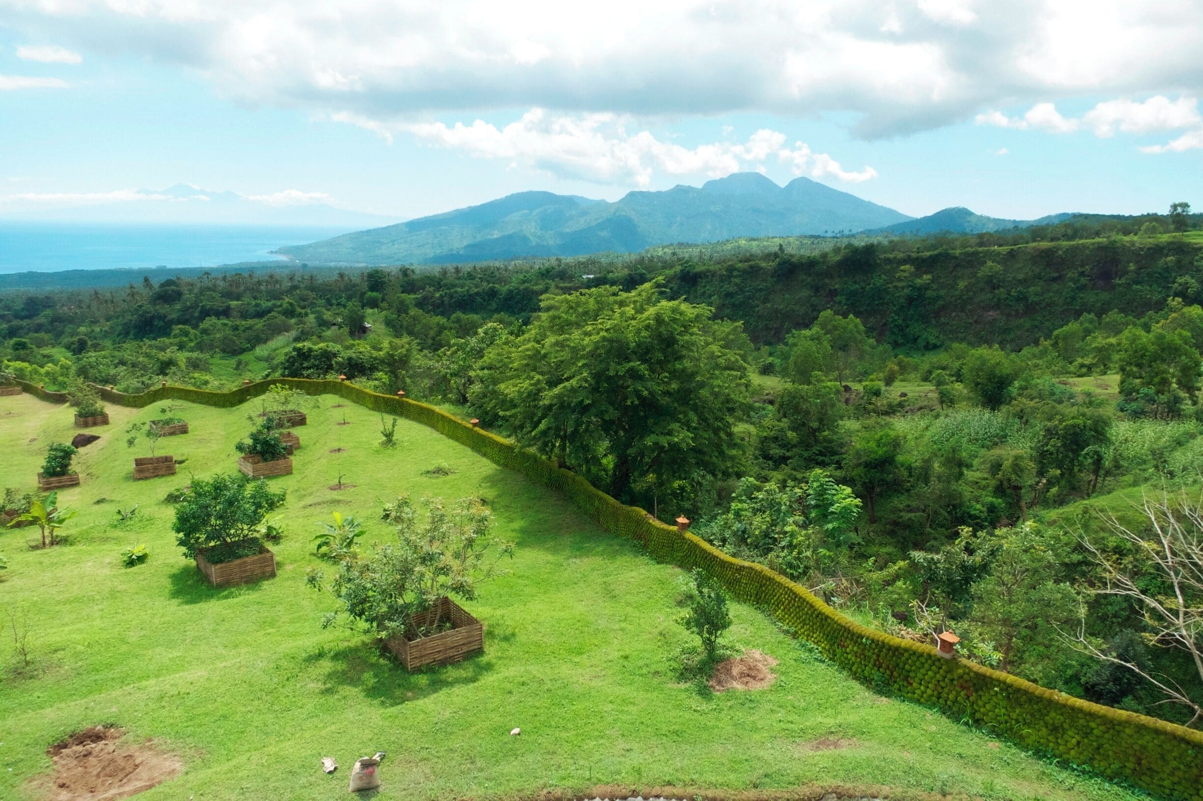 A Beautiful View!  It's hard to see in the photo, but that's the nearby island of Lombok in the far left corner. This was a small Hindu garden/shrine thats's a 20 minute drive up the mountain from Tulamben.  (ask a local to take you there.) The sea in one direction, and the volcano in the other.  Gorgeous!