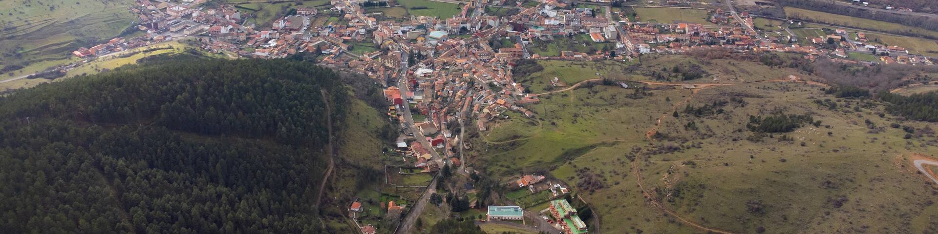 Cistierna, spain, surrounded by mountains and forests, seen from above