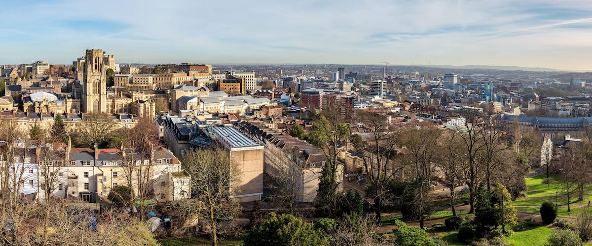 A cityscape with historic architecture, including a prominent cathedral and modern buildings.