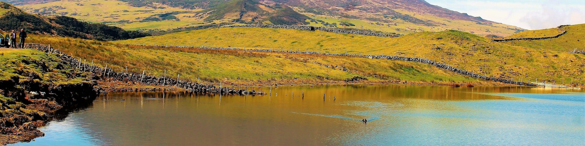 Portugal's highest mountain! Mt. Pico in Azores Islandsl! Pico Island was my last day in the Azores and it was my only day there. A great way to end my March 2019 trip. This majestic volcano is 2,351 m (7,713 ft) above sea level, and is one of the highest Atlantic mountains; it is more than twice the elevation of any other peak in the Azores. And there are breathtaking views from all across the small volcanic island. I got many good shots of it, including this one.
I took a tour around some parts of the island, before flying out of the Azores that day. It was a really great way to end this trip! And this being one of the best spots to see the volcano. It's an idyllic lake view! There was even some birds in the water :). Also, Pico doesn't have nearly as many tourists as the main Azores island. Which makes this all the more peaceful. And in the tradition of the Portuguese poet, Raul Brandão, Pico is referred to as the Ilha Preta ("Black Island"), for its black volcanic earth, responsible for its UNESCO-designated historical vineyards that allowed the development of the island. If anyone goes to the Azores I really recommend a stay on Pico!