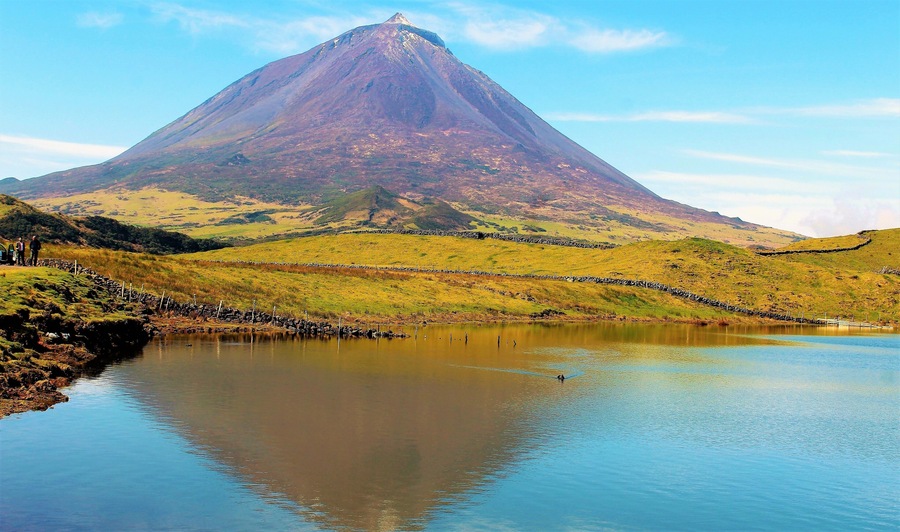 Portugal's highest mountain! Mt. Pico in Azores Islandsl! Pico Island was my last day in the Azores and it was my only day there. A great way to end my March 2019 trip. This majestic volcano is 2,351 m (7,713 ft) above sea level, and is one of the highest Atlantic mountains; it is more than twice the elevation of any other peak in the Azores. And there are breathtaking views from all across the small volcanic island. I got many good shots of it, including this one.
I took a tour around some parts of the island, before flying out of the Azores that day. It was a really great way to end this trip! And this being one of the best spots to see the volcano. It's an idyllic lake view! There was even some birds in the water :). Also, Pico doesn't have nearly as many tourists as the main Azores island. Which makes this all the more peaceful. And in the tradition of the Portuguese poet, Raul Brandão, Pico is referred to as the Ilha Preta ("Black Island"), for its black volcanic earth, responsible for its UNESCO-designated historical vineyards that allowed the development of the island. If anyone goes to the Azores I really recommend a stay on Pico!
