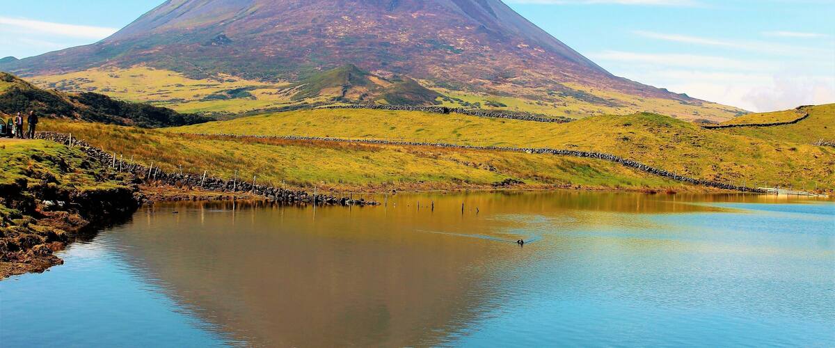 A mountain with a lake in the foreground.