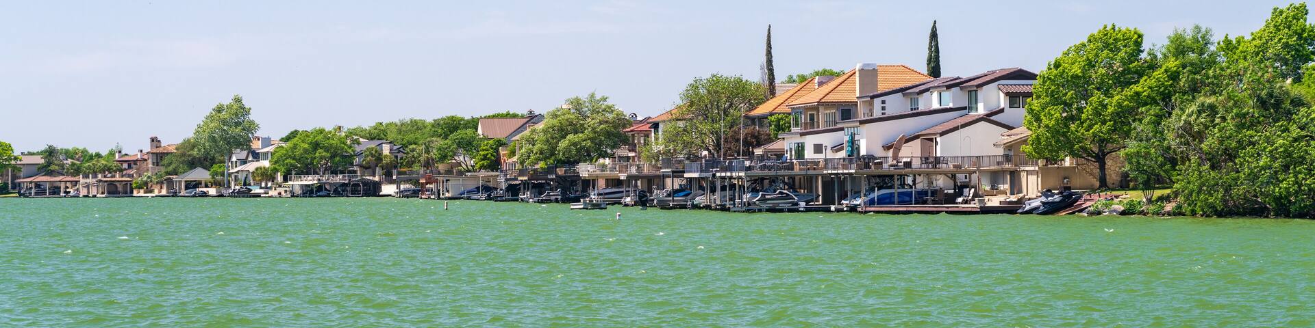Luxury homes line the lakeshore with boat docks on LBJ Lake in Horseshoe Bay Texas