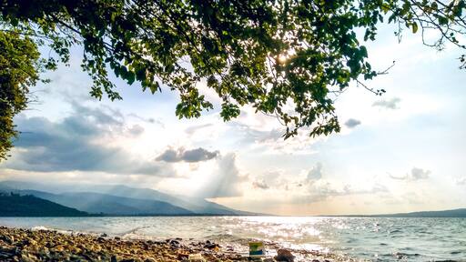 A wavy lakeside view of Sapanca Lake with dramatic light and sky.