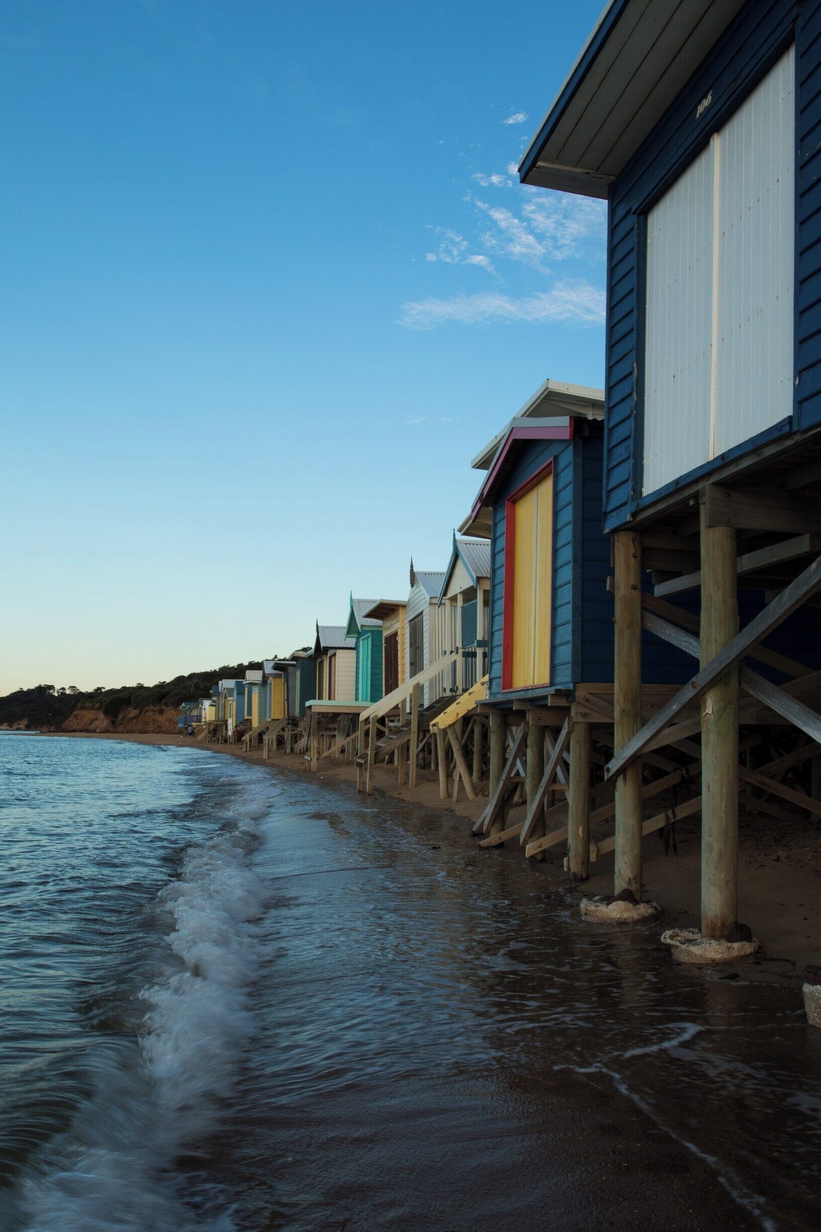 A big feature of the beaches that line the eastern shorelines of Port Phillip Bay in Victoria are the brightly coloured beach bathing boxes. Mount Martha has some spectacular examples of these curious structures, especially these where the stairs hang suspended over the water. And there is nothing like a sunset on the beach.

