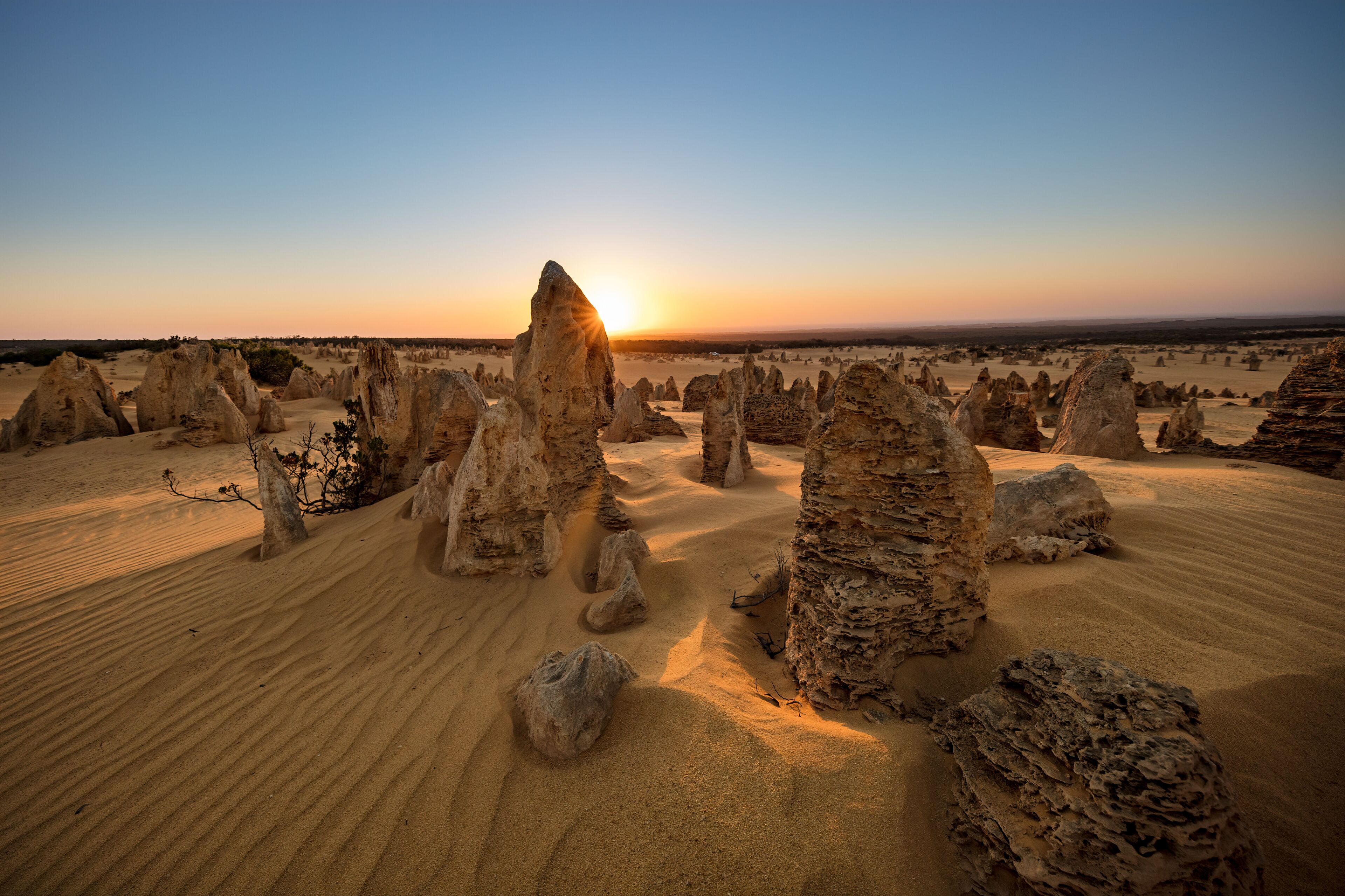 Sun setting behind the limestone stacks in the Pinnacles desert in the Nambung national park located north of Perth in Western Australia