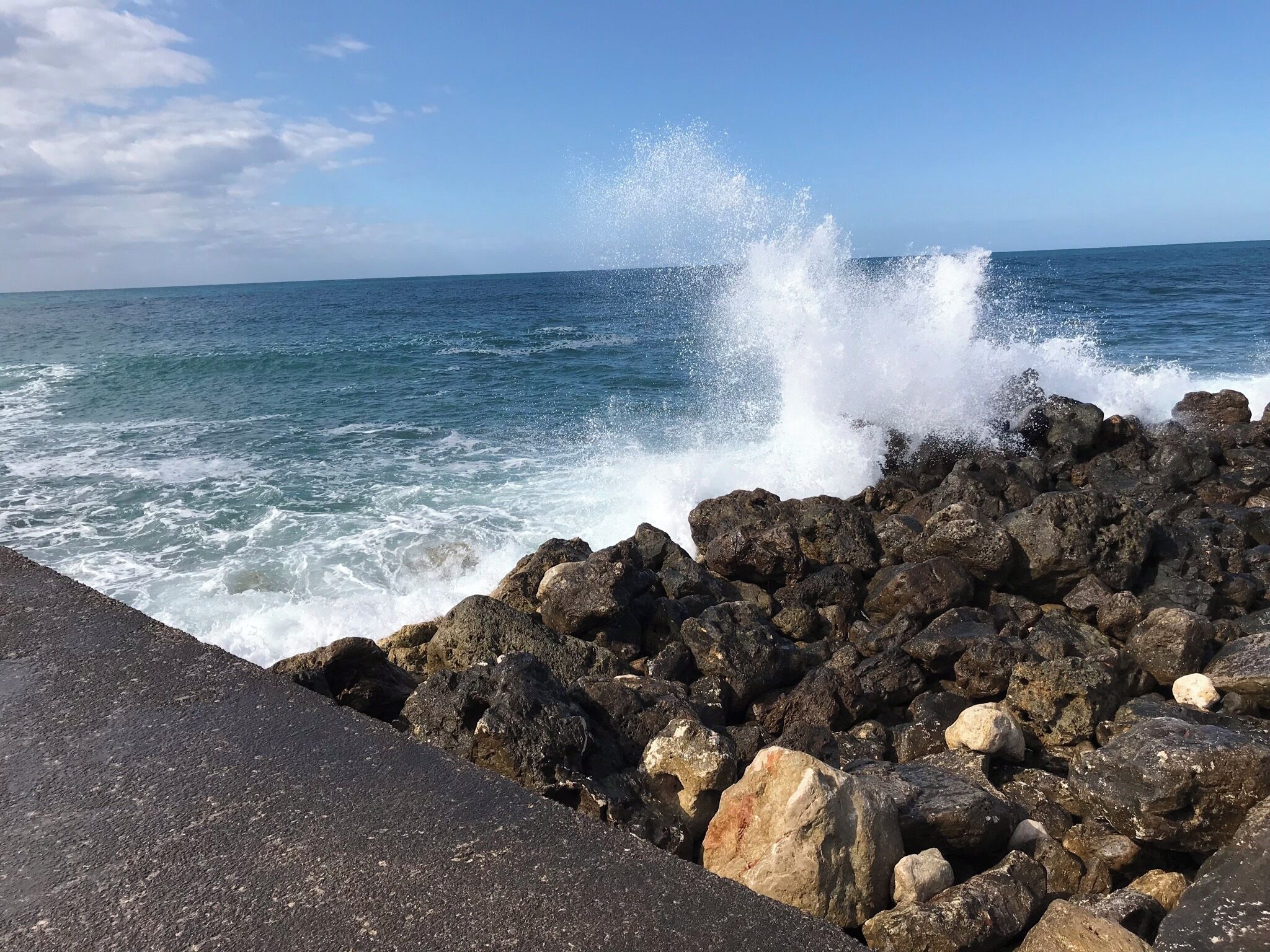A rocky shoreline with waves crashing against the rocks.