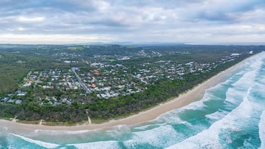 Wide aerial panorama of ocean coastline and Suffolk Park suburb in NSW, Australia