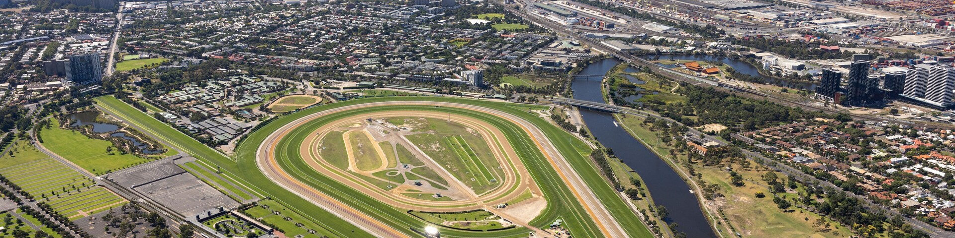 Aerial view of a beautiful horse race track surrounded by a vibrant cityscape and river, Maribyrnong, Victoria, Australia.