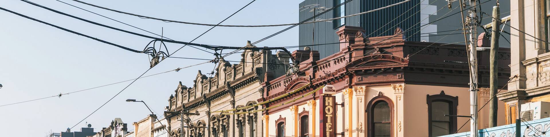 A street lined with historic buildings, a public bar, and a dining hall.
