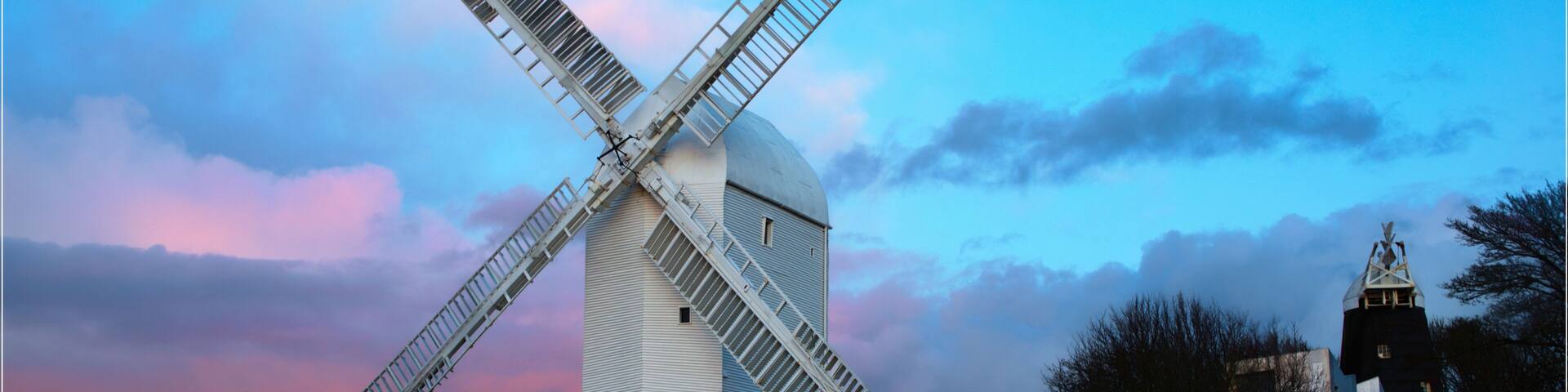 windmills at sunset in pink and blue