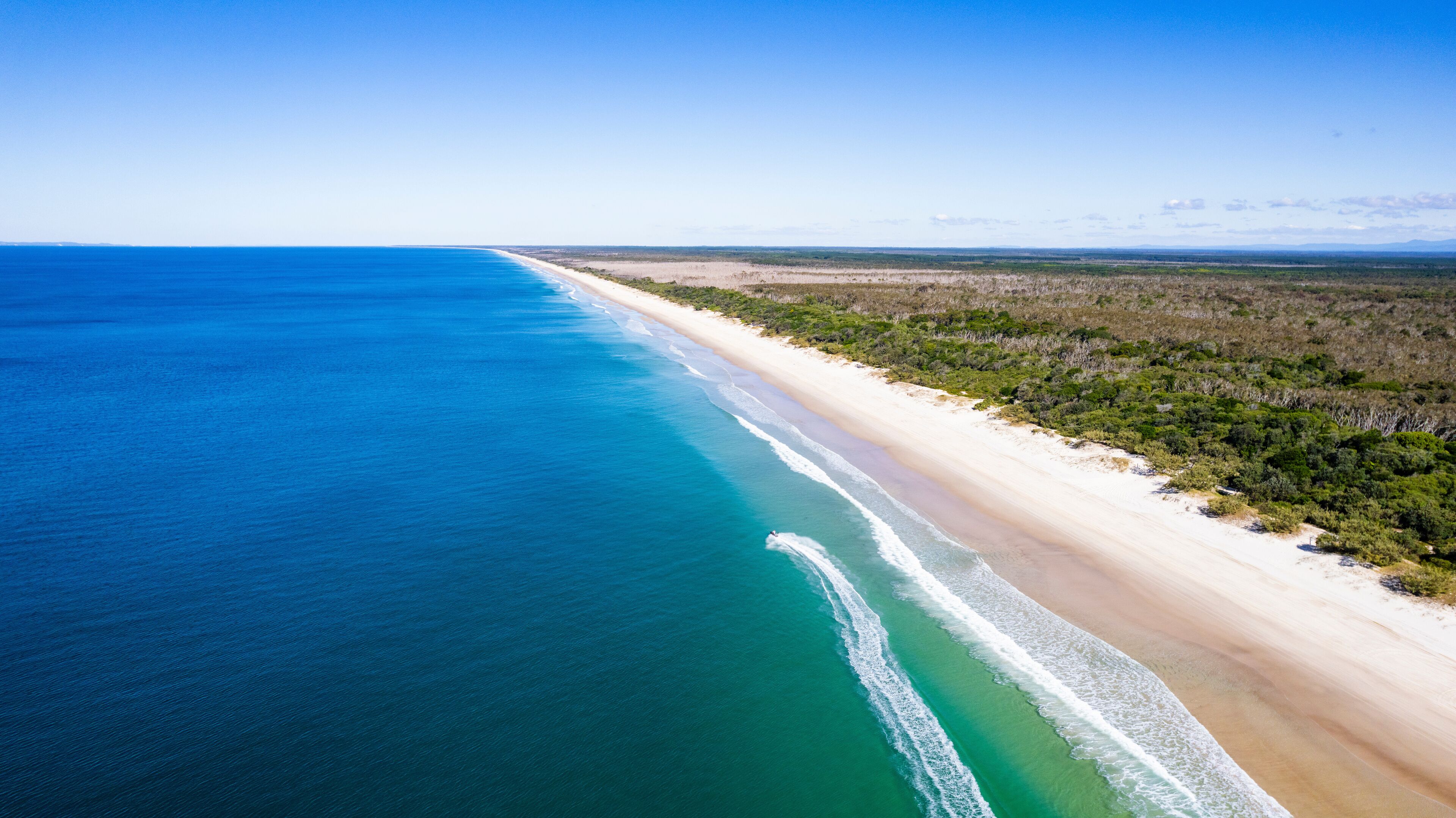 Aerial view of beautiful Ocean Beach with Jetski, Bribie Island, Queensland, Australia.