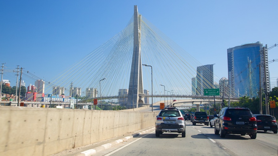 A busy highway with a cable-stayed bridge in the background.