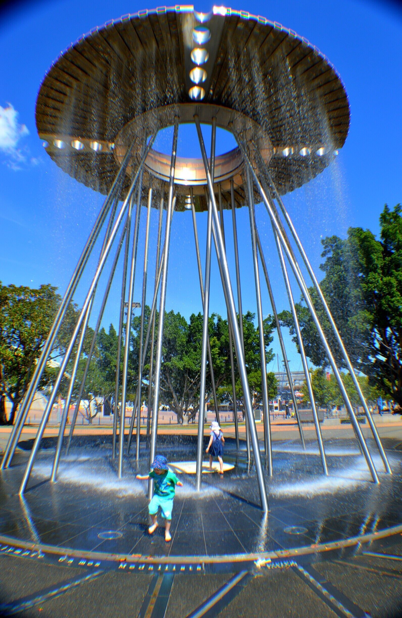 The world famous Cauldron that Cathy Freeman lit in the Sydney 2000 Olympic games.  My kids are having a ball getting wet on a hot summer's day. 