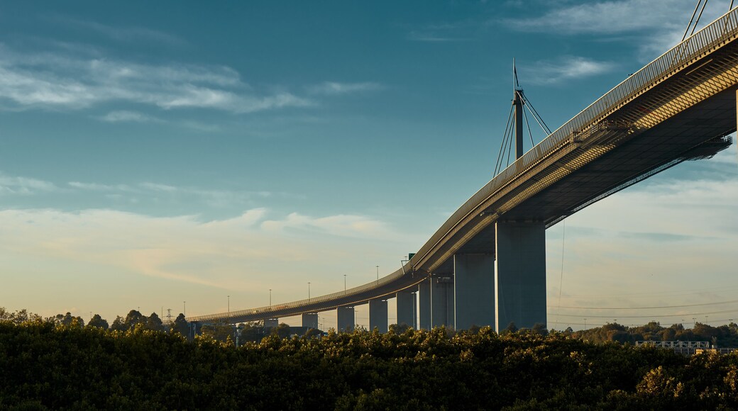 Westgate bridge in Melbourne on a beautiful, sligthly cloudy monrning, lit by the golden Australian sun.